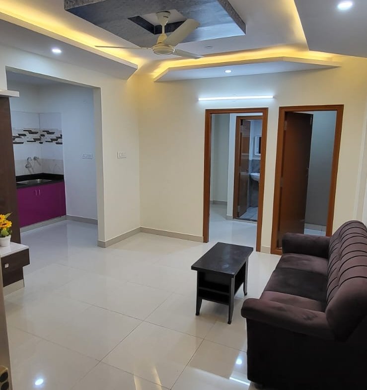 Hall with sofa and table in 1bhk fully furnished flat