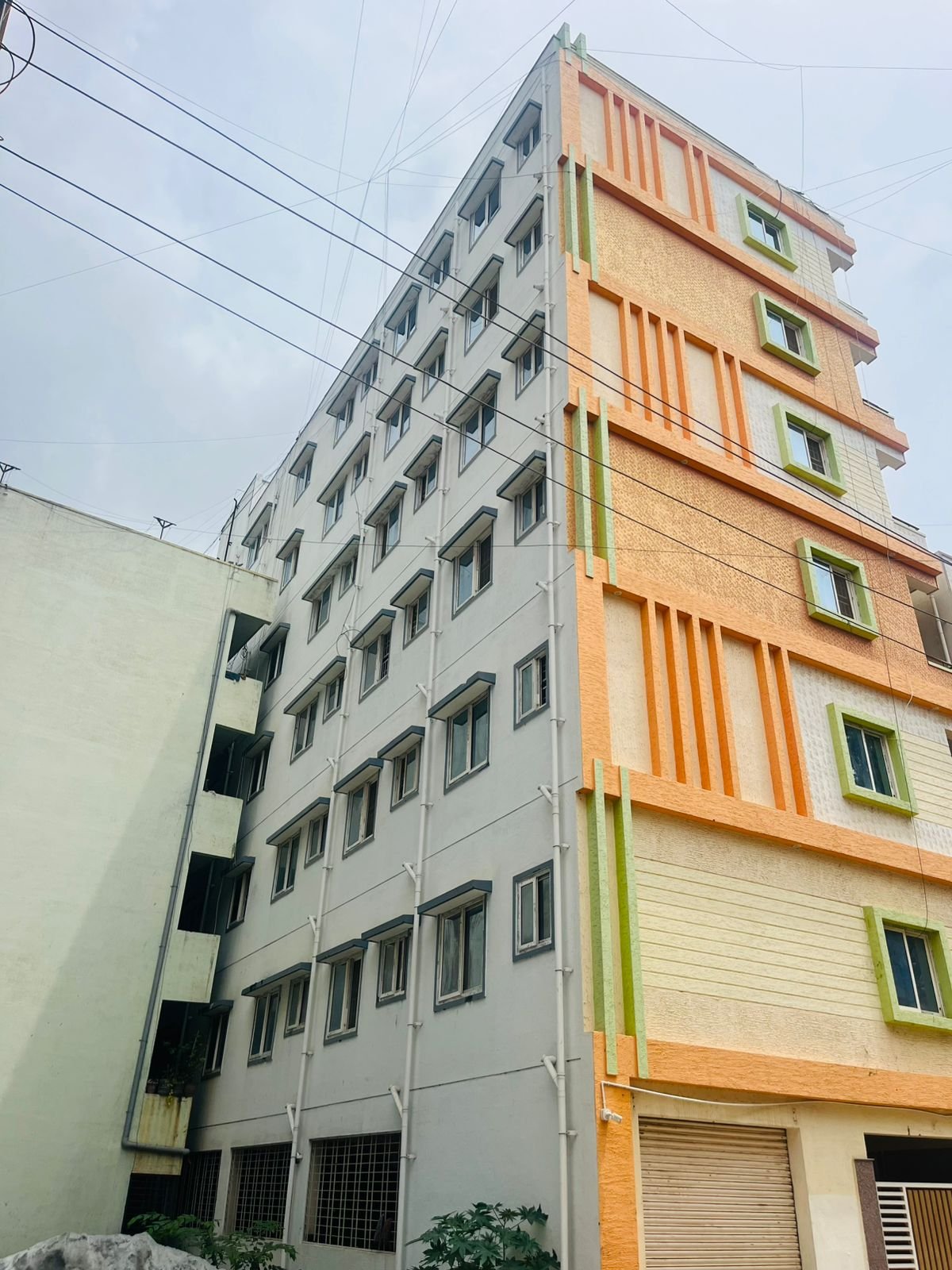 Exterior view of G+6 rental income building with 38 units and commercial shops in Electronic City Phase 2 Bangalore generating ₹3.2 lakh monthly rent