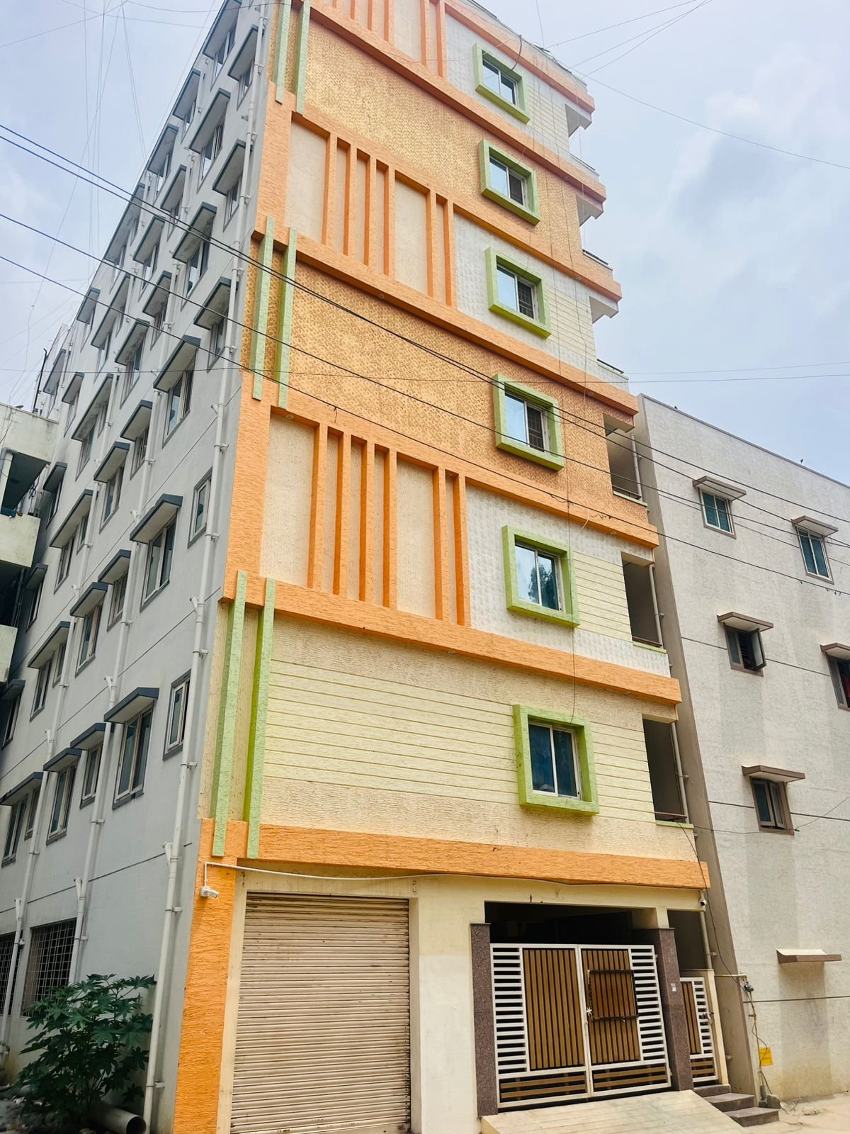 Exterior view of G+6 rental income building with 38 units and commercial shops in Electronic City Phase 2 Bangalore generating ₹3.2 lakh monthly rent