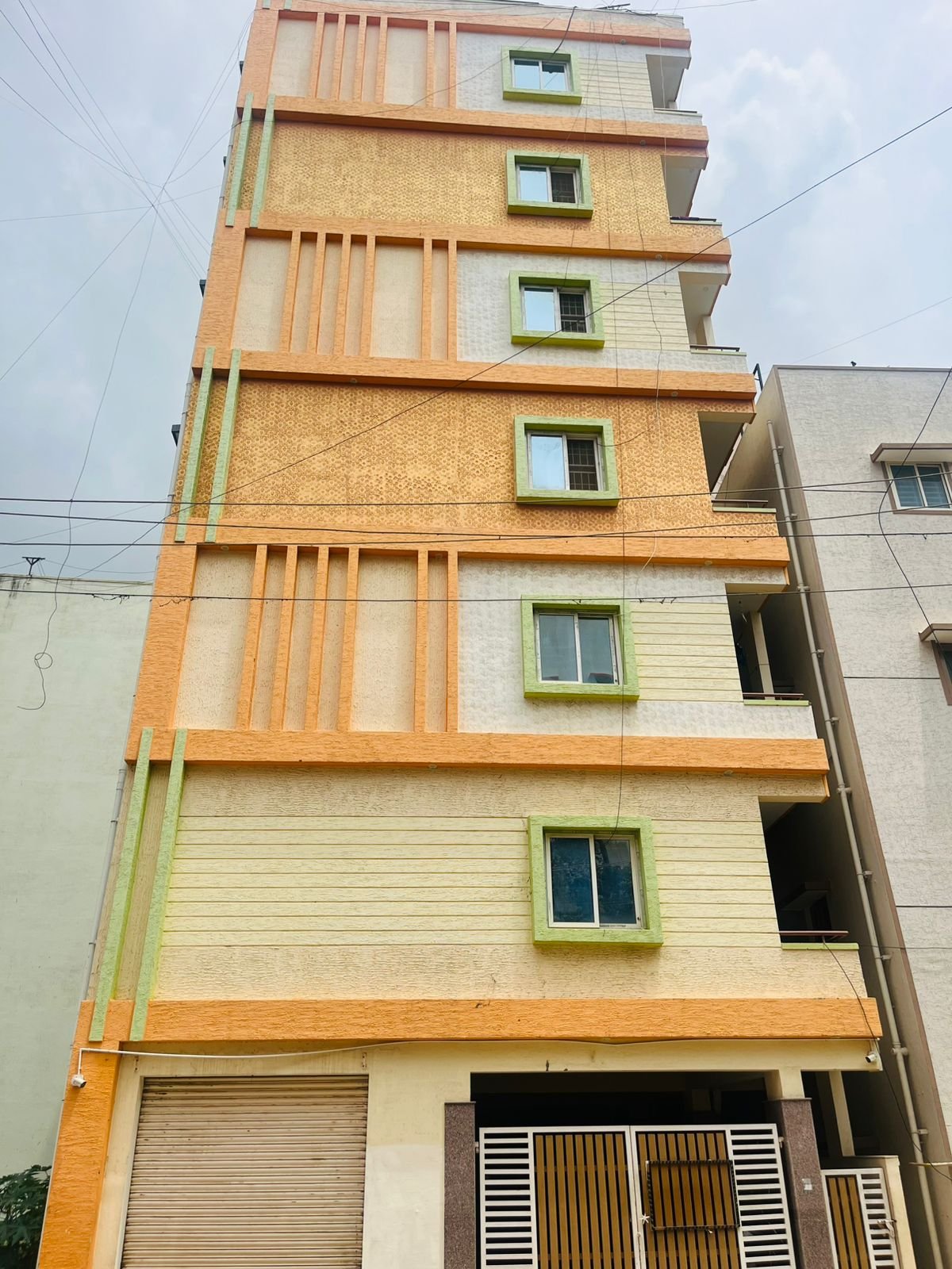 Exterior view of G+6 rental income building with 38 units and commercial shops in Electronic City Phase 2 Bangalore generating ₹3.2 lakh monthly rent