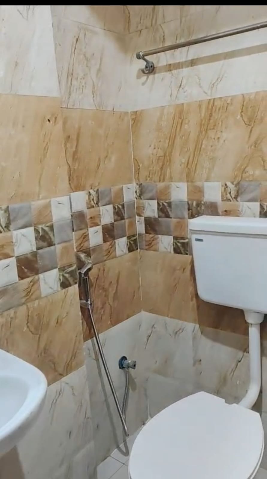 Premium attached washroom with shower geyser tiles and modern fittings in Christ University PG