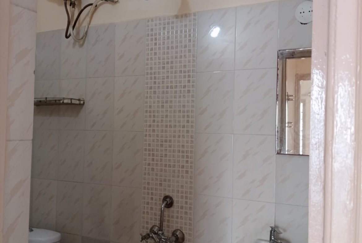 Western bathroom with geyser, shower and wash basin in furnished 2BHK flat