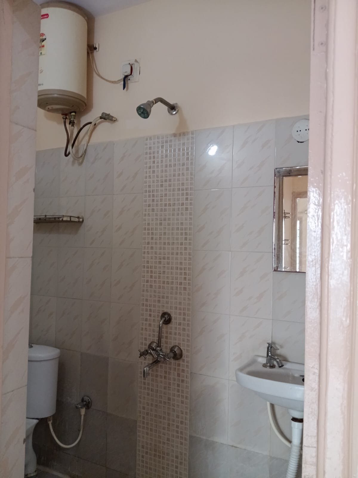 Western bathroom with geyser, shower and wash basin in furnished 2BHK flat
