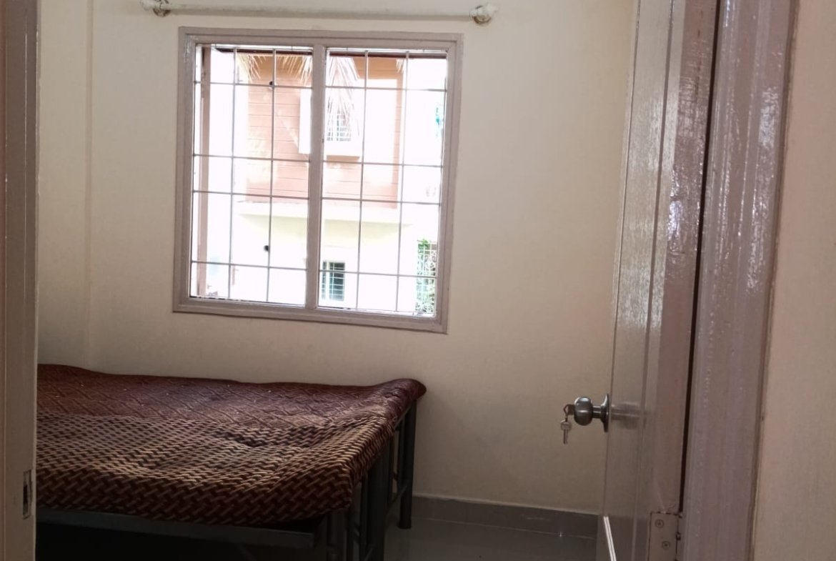 Bedroom with king size bed, mattress, wardrobe and natural light in 2BHK apartment