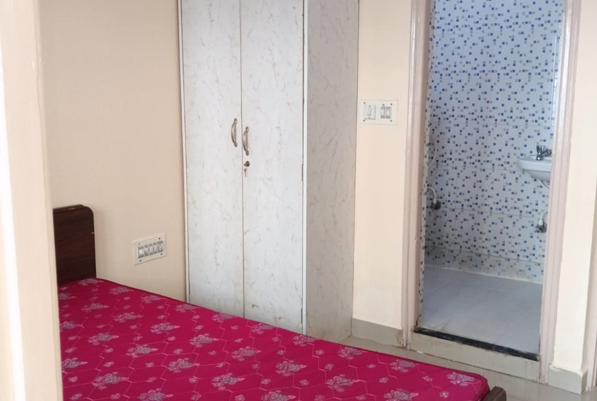 Bedroom with king size bed, mattress, wardrobe and natural light in 2BHK apartment
