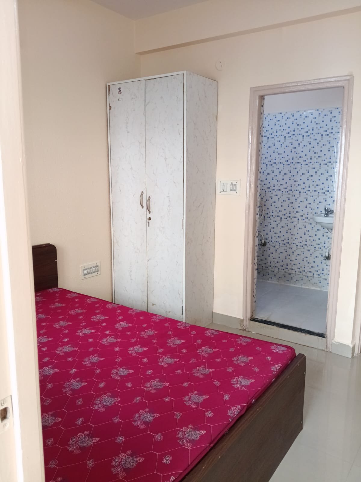 Bedroom with king size bed, mattress, wardrobe and natural light in 2BHK apartment