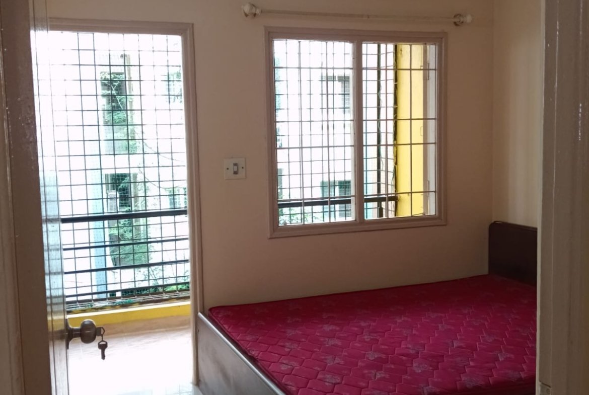 Bedroom with king size bed, mattress, wardrobe and natural light in 2BHK apartment