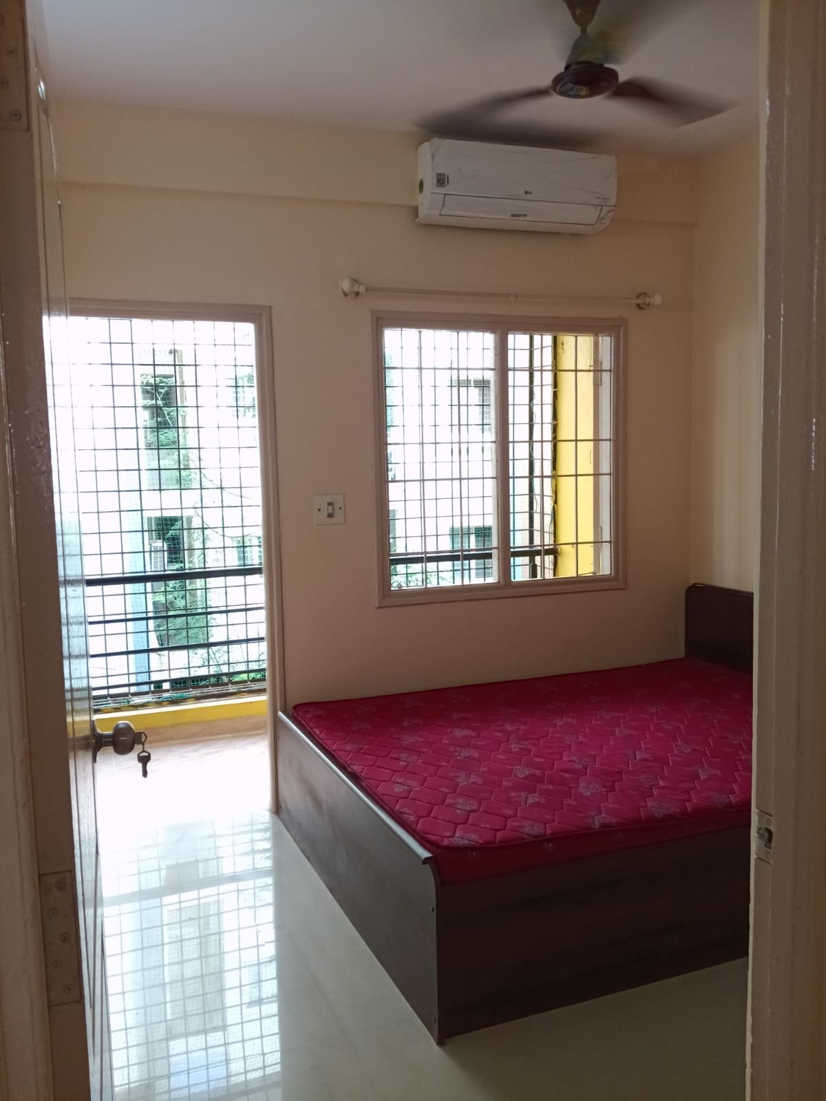 Bedroom with king size bed, mattress, wardrobe and natural light in 2BHK apartment