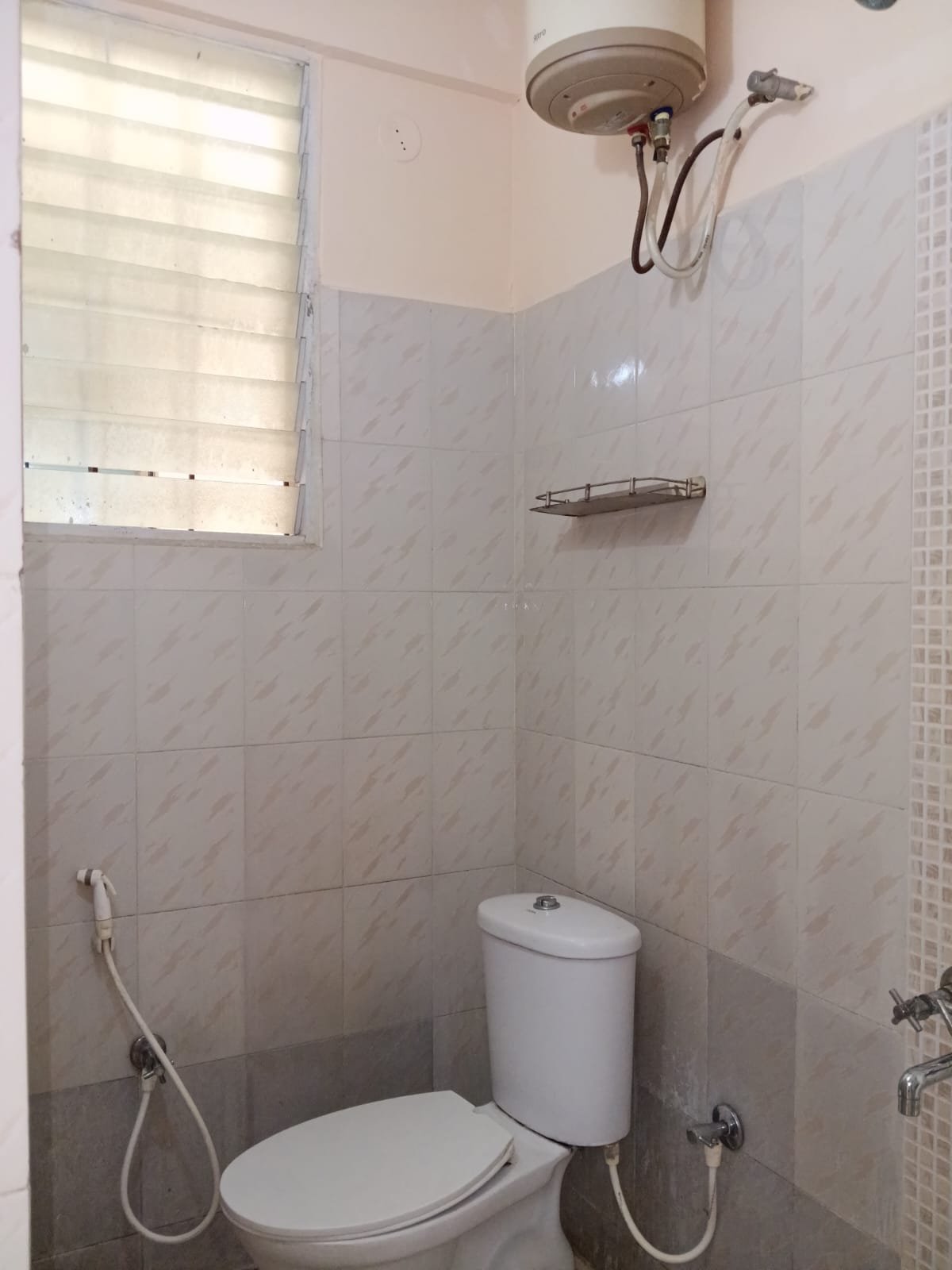Western bathroom with geyser, shower and wash basin in furnished 2BHK flat