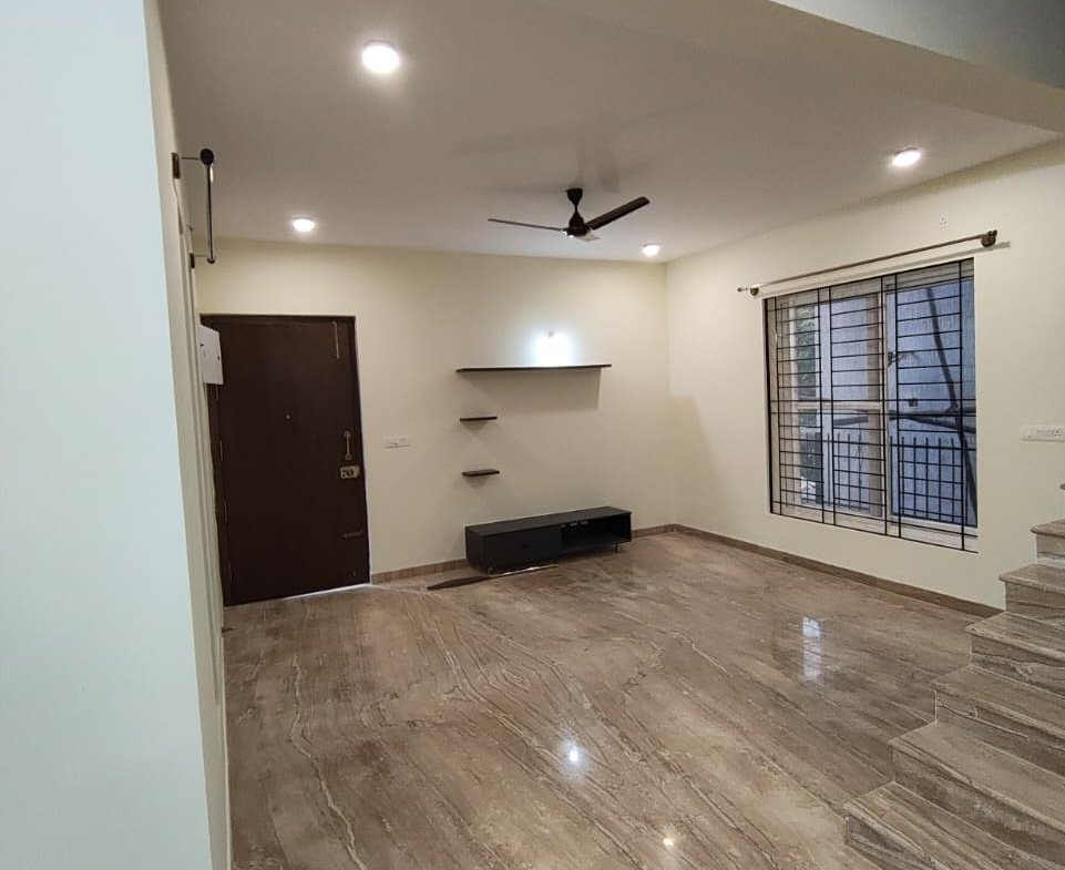 Large living room with natural lighting in semi furnished villa at Woodsvale Sarjapura