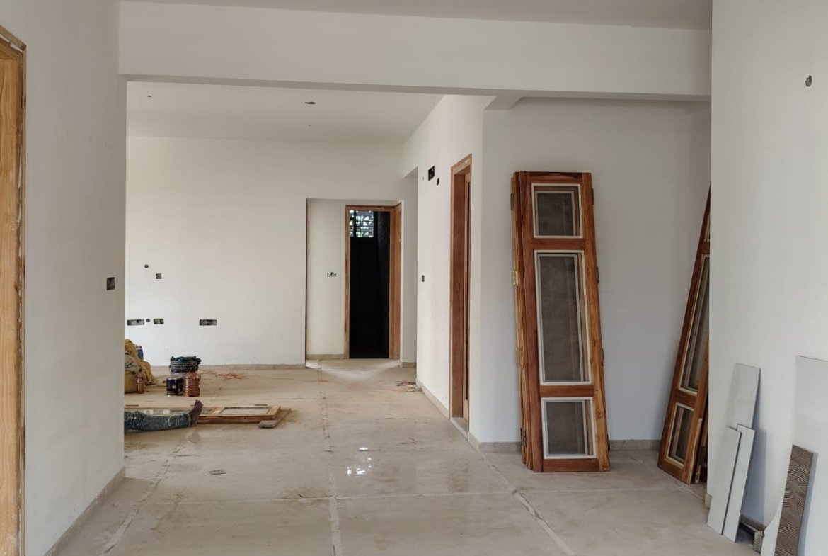 Spacious living room interior of 3BHK flat with balcony and natural light