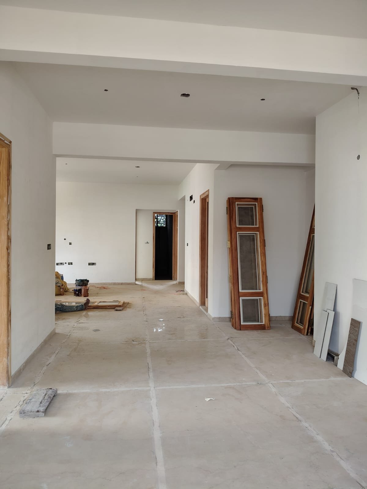 Spacious living room interior of 3BHK flat with balcony and natural light