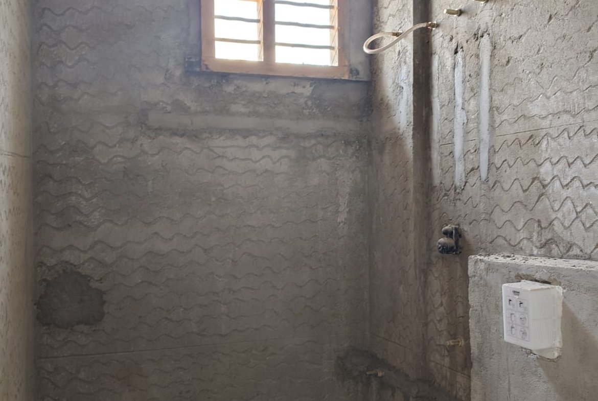 Modern bathroom with premium fittings and wall tiles in residential apartment