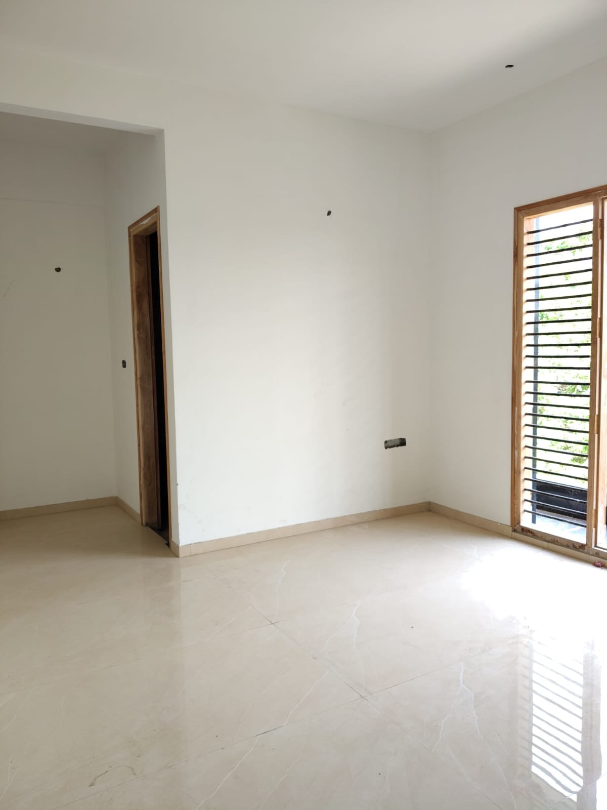 Master bedroom in 3BHK flat with balcony and natural ventilation