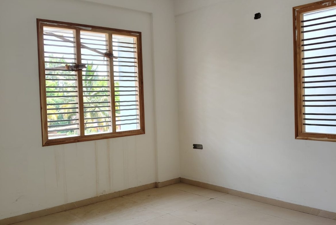 Master bedroom in 3BHK flat with balcony and natural ventilation