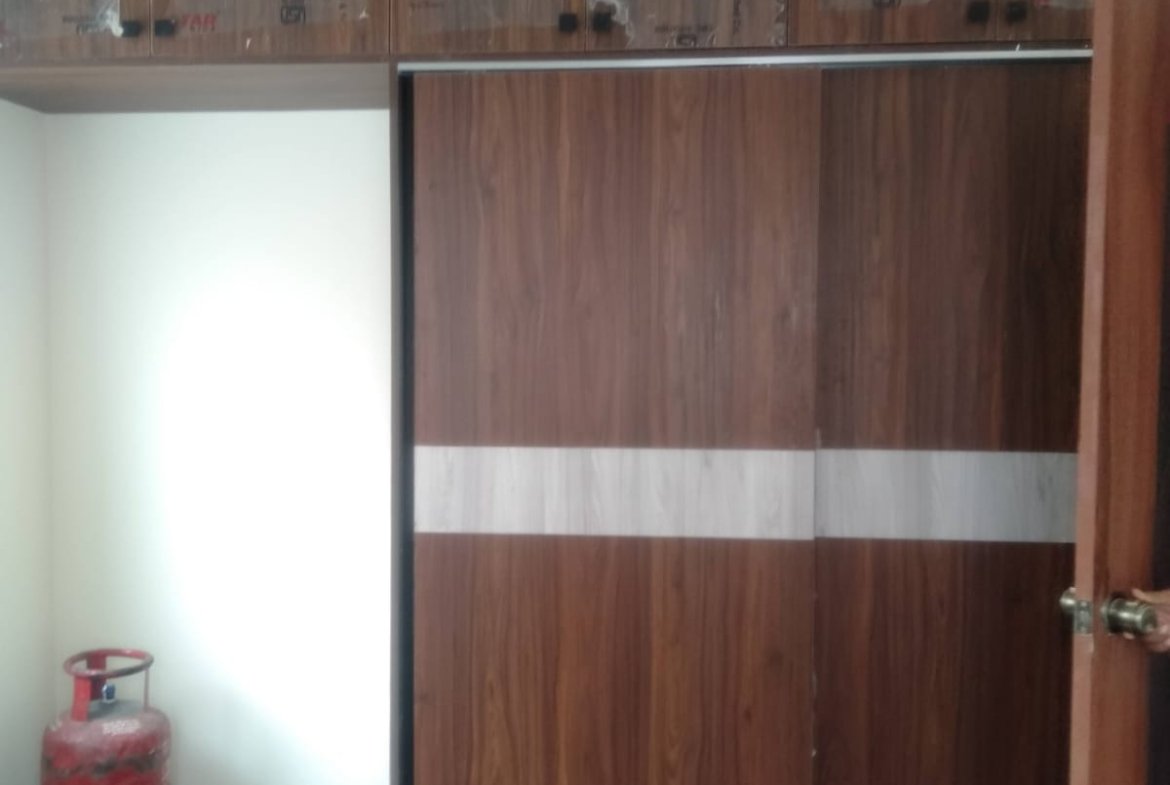 Cozy bedroom in 1200sqft 2BHK flat with balcony cupboards and balcony view Bannerghatta Road Bangalore.