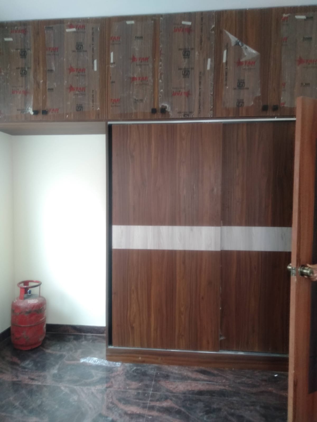 Cozy bedroom in 1200sqft 2BHK flat with balcony cupboards and balcony view Bannerghatta Road Bangalore.