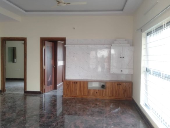 Spacious living room in premium 2BHK semi-furnished flat near Decathlon Bannerghatta Road Bangalore with modern sofa open layout and natural light.