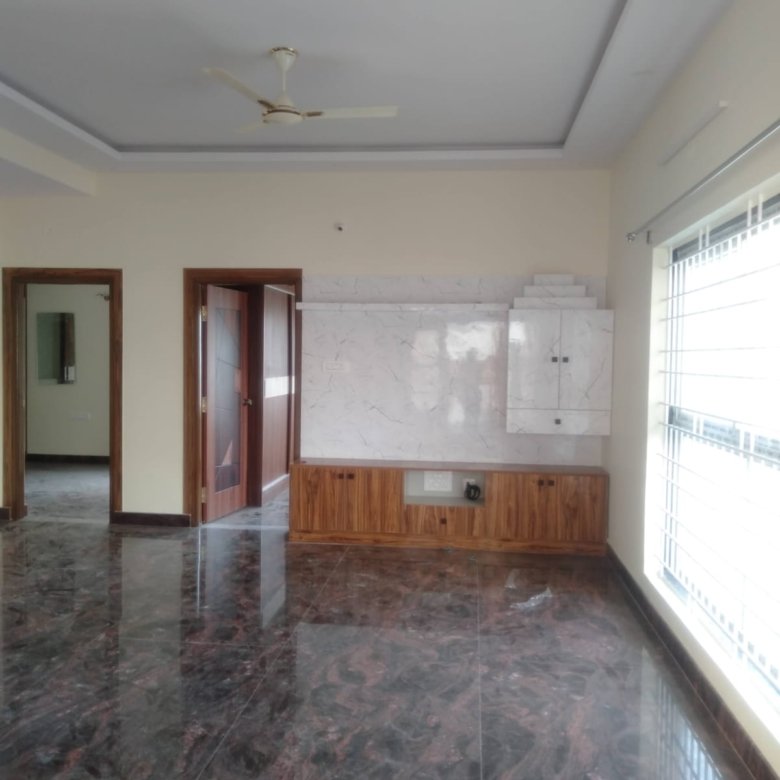 Spacious living room in premium 2BHK semi-furnished flat near Decathlon Bannerghatta Road Bangalore with modern sofa open layout and natural light.