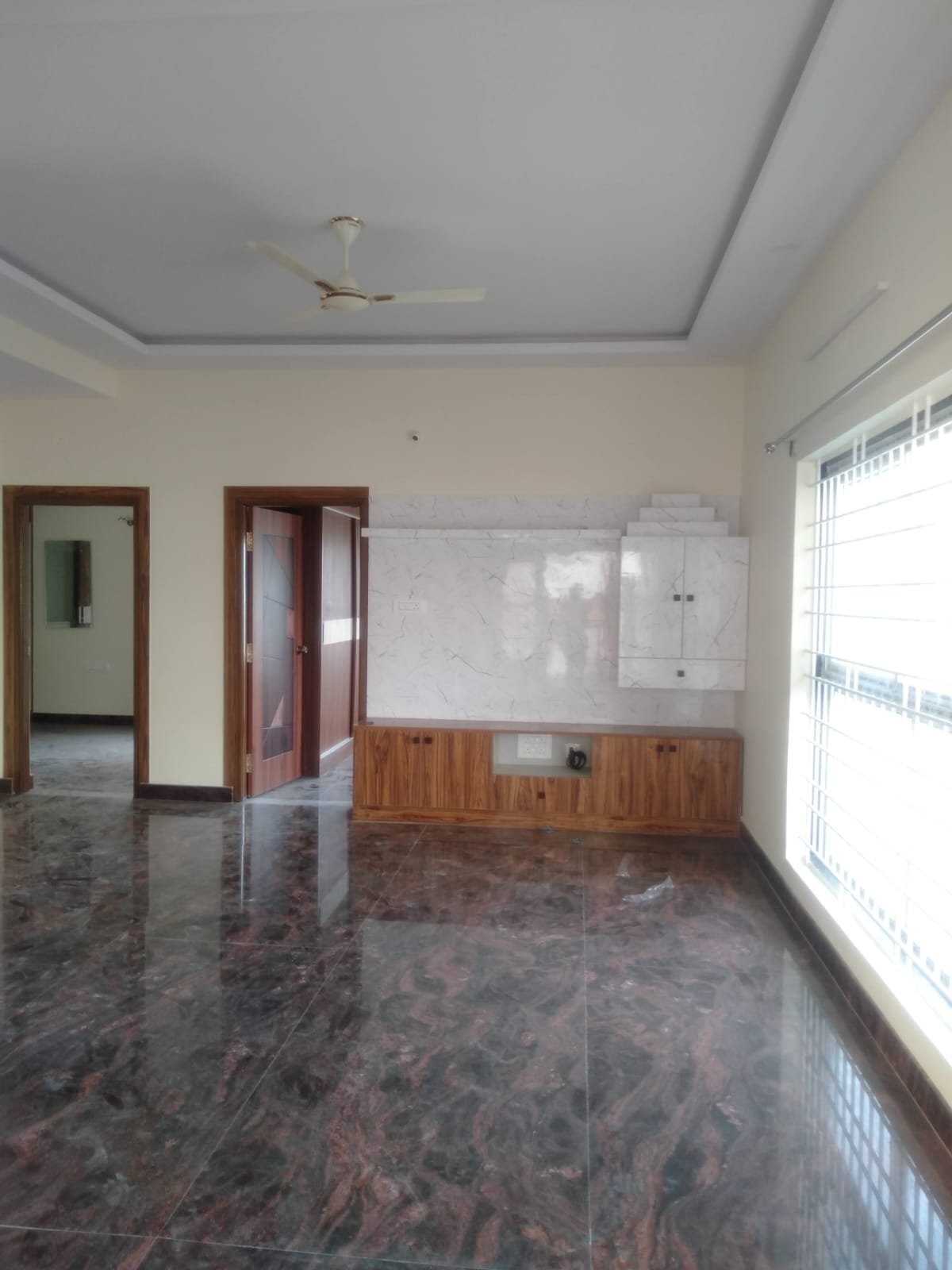Spacious living room in premium 2BHK semi-furnished flat near Decathlon Bannerghatta Road Bangalore with modern sofa open layout and natural light.