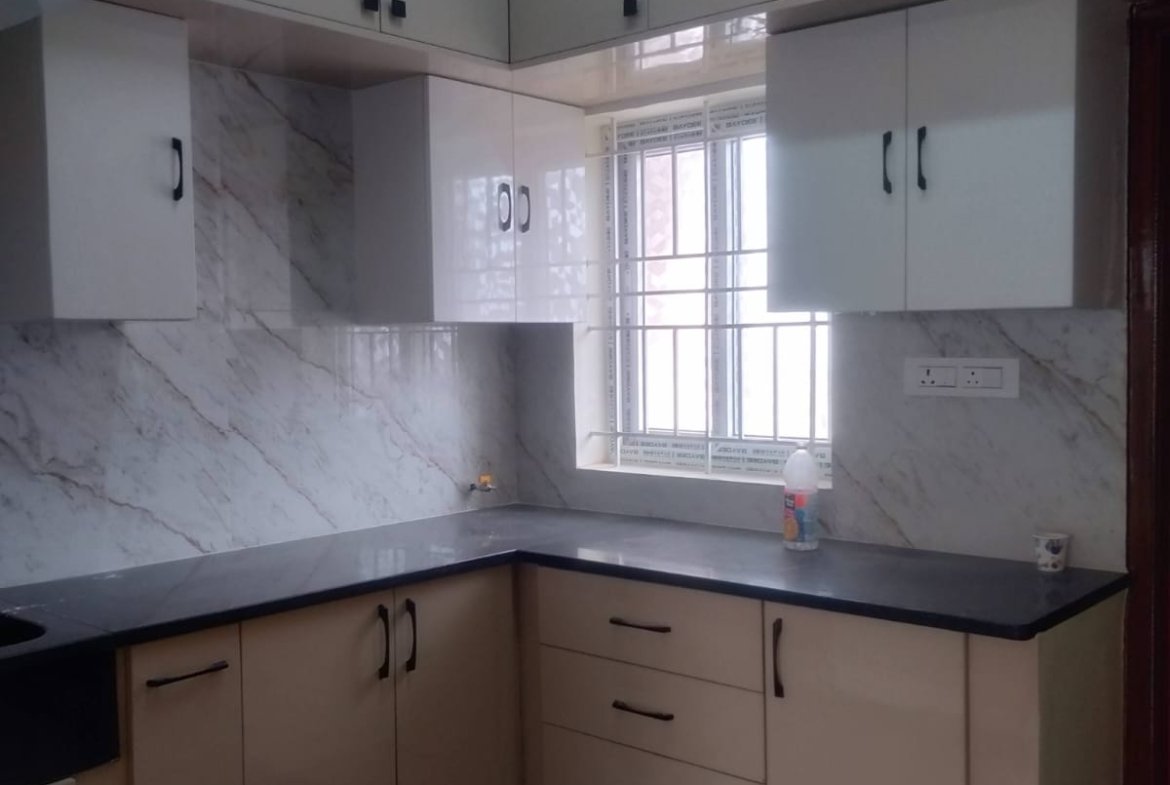 Modular kitchen in 2BHK rental flat Bannerghatta Road with cupboards geyser granite countertop and premium fittings.