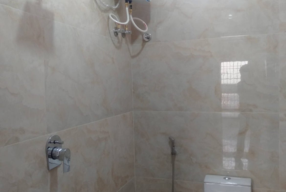Modern 2BHK washroom with premium fittings anti-slip tiles and ample storage near Bannerghatta Main Road.