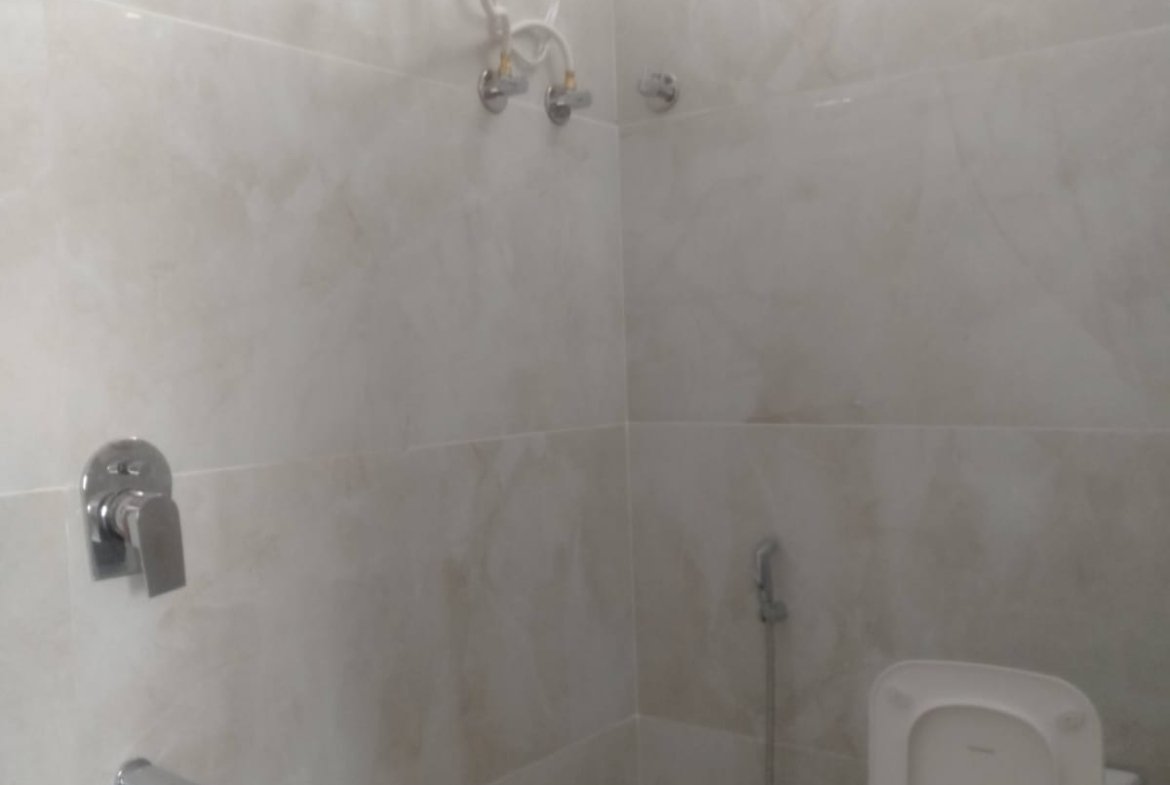 Modern 2BHK washroom with premium fittings anti-slip tiles and ample storage near Bannerghatta Main Road.
