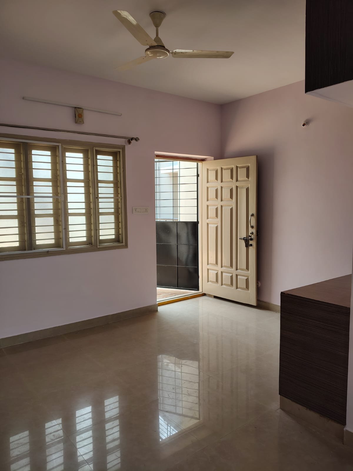 Spacious living room in 1BHK flat near Decathlon Bannerghatta Main Road with good ventilation